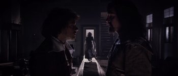 Movie still from “Nightwatching” (2007), directed by Peter Greenaway – Two men and a woman standing in front of an open door; Wide shot, Over the shoulder angle