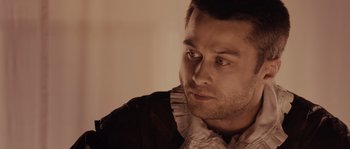 Movie still from “Nightwatching” (2007), directed by Peter Greenaway – A person wearing a shirt; Close Up shot, Over the shoulder angle