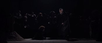 Movie still from “Nightwatching” (2007), directed by Peter Greenaway – An old man and a young girl in a dark room; Wide shot, High angle