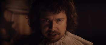 Movie still from “Nightwatching” (2007), directed by Peter Greenaway – A person wearing a white shirt; Close Up shot, Low angle
