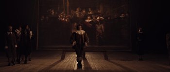 Movie still from “Nightwatching” (2007), directed by Peter Greenaway – A man dressed as a man with a beard and a hat; Wide shot, Low angle
