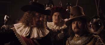 Movie still from “Nightwatching” (2007), directed by Peter Greenaway – A group of men in medieval costumes standing next to each other; Medium shot, Over the shoulder angle