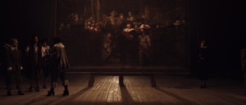 Movie still from “Nightwatching” (2007), directed by Peter Greenaway – A group of people standing in front of a painting; Extreme Wide shot, Low angle