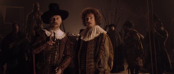 Movie still from “Nightwatching” (2007), directed by Peter Greenaway – Two men dressed in renaissance clothing standing next to each other; Medium shot, Over the shoulder angle