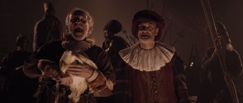 Movie still from “Nightwatching” (2007), directed by Peter Greenaway – A group of people dressed up in costumes; Medium shot, Low angle