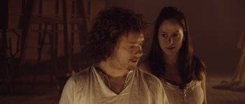 Movie still from “Nightwatching” (2007), directed by Peter Greenaway – A man and a woman standing next to each other in a room; Close Up shot, Over the shoulder angle