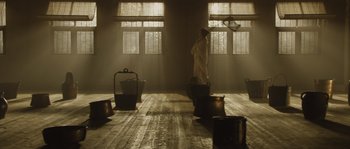 Movie still from “Nightwatching” (2007), directed by Peter Greenaway – A person standing in a room; Wide shot, Low angle