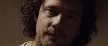 Movie still from “Nightwatching” (2007), directed by Peter Greenaway – A person with a beard; Extreme Close Up shot, Low angle