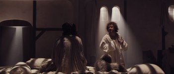 Movie still from “Nightwatching” (2007), directed by Peter Greenaway – A man in a white robe is standing in front of a mirror; Wide shot, Over the shoulder angle