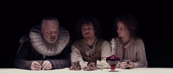Movie still from “Nightwatching” (2007), directed by Peter Greenaway – A group of people sitting at a dinner table; Medium shot, Over the shoulder angle