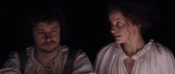 Movie still from “Nightwatching” (2007), directed by Peter Greenaway – A man and a woman looking at each other in the dark; Close Up shot, High angle