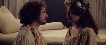 Movie still from “Nightwatching” (2007), directed by Peter Greenaway – A man and a woman standing next to each other; Close Up shot, Overhead angle