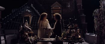 Two people are shaking hands in a room full of decorations
