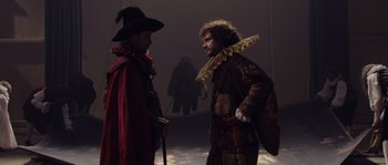 Movie still from “Nightwatching” (2007), directed by Peter Greenaway – Two men dressed in costumes talking to each other; Medium shot, Over the shoulder angle