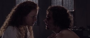 Movie still from “Nightwatching” (2007), directed by Peter Greenaway – A man and a woman face to face in a dark room; Close Up shot, Over the shoulder angle