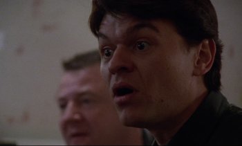 Movie still from “Nil by Mouth” (1997), directed by Gary Oldman – A man with a surprised look on his face; Close Up shot, Low angle