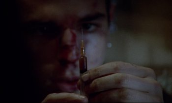 Movie still from “Nil by Mouth” (1997), directed by Gary Oldman – A person holding a needle; Extreme Close Up shot, Overhead angle