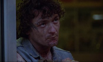 Movie still from “Nil by Mouth” (1997), directed by Gary Oldman – A person wearing a shirt; Close Up shot, Low angle