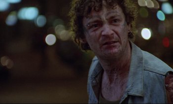 Movie still from “Nil by Mouth” (1997), directed by Gary Oldman – A person with curly hair; Close Up shot, Low angle