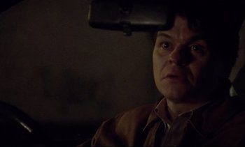 Movie still from “Nil by Mouth” (1997), directed by Gary Oldman – A man in a brown jacket looking at the camera; Close Up shot, High angle