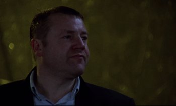 Movie still from “Nil by Mouth” (1997), directed by Gary Oldman – A person wearing a jacket; Close Up shot, Low angle