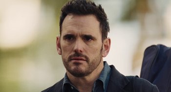 Movie still from “Nimic” (2019), directed by Yorgos Lanthimos – A person wearing a jacket; Close Up shot, Over the shoulder angle