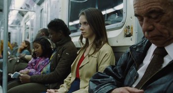 Movie still from “Nimic” (2019), directed by Yorgos Lanthimos – A woman sitting on a bus with other passengers; Medium shot, Over the shoulder angle