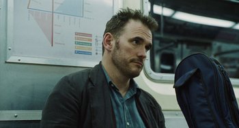 Movie still from “Nimic” (2019), directed by Yorgos Lanthimos – A person sitting on a train; Close Up shot, Over the shoulder angle