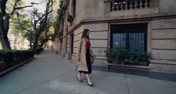 Movie still from “Nimic” (2019), directed by Yorgos Lanthimos – A woman walking down the street wearing a trench coat; Wide shot, Low angle