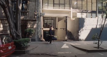 Movie still from “Nimic” (2019), directed by Yorgos Lanthimos – A person walking down the street with a suitcase; Extreme Wide shot, High angle