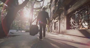 Movie still from “Nimic” (2019), directed by Yorgos Lanthimos – A man walking down the street with a bag of luggage; Wide shot, Low angle