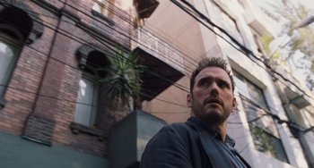 Movie still from “Nimic” (2019), directed by Yorgos Lanthimos – A person standing outside of a building; Close Up shot, Low angle
