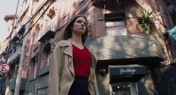 Movie still from “Nimic” (2019), directed by Yorgos Lanthimos – A woman in a red shirt and a tan jacket; Medium shot, Low angle