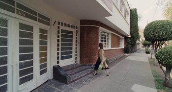 Movie still from “Nimic” (2019), directed by Yorgos Lanthimos – Two women walking down the sidewalk in front of a building; Wide shot, Low angle