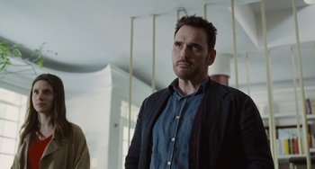 Movie still from “Nimic” (2019), directed by Yorgos Lanthimos – A man standing in front of another man in a room; Close Up shot, Low angle