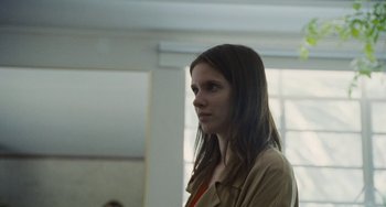 Movie still from “Nimic” (2019), directed by Yorgos Lanthimos – A woman in a tan shirt looking to her left; Close Up shot, Low angle
