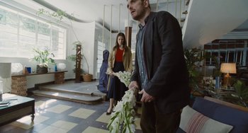 Movie still from “Nimic” (2019), directed by Yorgos Lanthimos – A man and a woman in a room with stairs; Medium shot, Low angle