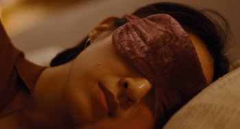 Movie still from “Nimic” (2019), directed by Yorgos Lanthimos – A person wearing a sleep eye mask; Extreme Close Up shot, High angle