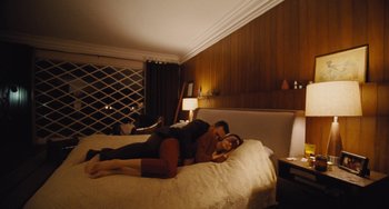 Movie still from “Nimic” (2019), directed by Yorgos Lanthimos – A man and a woman are laying on a bed; Wide shot, High angle