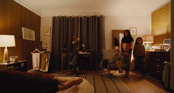 Movie still from “Nimic” (2019), directed by Yorgos Lanthimos – Two people are sitting in a living room; Wide shot, Over the shoulder angle