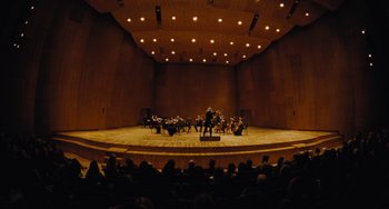 Movie still from “Nimic” (2019), directed by Yorgos Lanthimos – A large group of people are sitting in a large auditorium; Extreme Wide shot, High angle