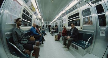 Movie still from “Nimic” (2019), directed by Yorgos Lanthimos – A group of people sitting on a subway train; Wide shot, High angle