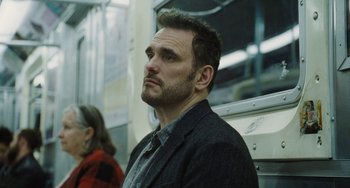 Movie still from “Nimic” (2019), directed by Yorgos Lanthimos – A person on a train looking at something; Close Up shot, Low angle