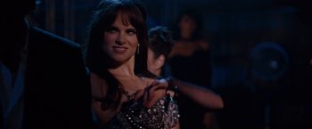 Movie still from “Nine” (2009), directed by Rob Marshall – A beautiful woman in a silver dress posing for a picture; Close Up shot, Over the shoulder angle