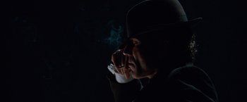 Movie still from “Nine” (2009), directed by Rob Marshall – A man smoking a cigarette in the dark; Close Up shot, Low angle