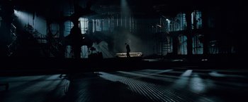 Movie still from “Nine” (2009), directed by Rob Marshall – A man standing in the middle of an empty warehouse; Extreme Wide shot, High angle