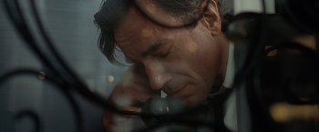 Movie still from “Nine” (2009), directed by Rob Marshall – A person leaning his head on his hand; Close Up shot, Low angle