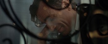 Movie still from “Nine” (2009), directed by Rob Marshall – A man's face through a magnifying glass; Extreme Close Up shot, Low angle