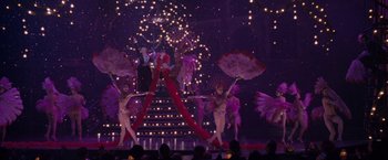 Movie still from “Nine” (2009), directed by Rob Marshall – A group of people performing on a stage; Extreme Wide shot, High angle