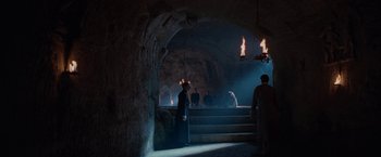 Movie still from “Nine” (2009), directed by Rob Marshall – A group of people standing in a cave with lights; Extreme Wide shot, High angle